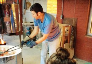 Jeff Vick removes ceramics from kiln