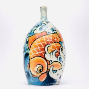 ceramic vase with tattoo art of a fish blue and orange in color